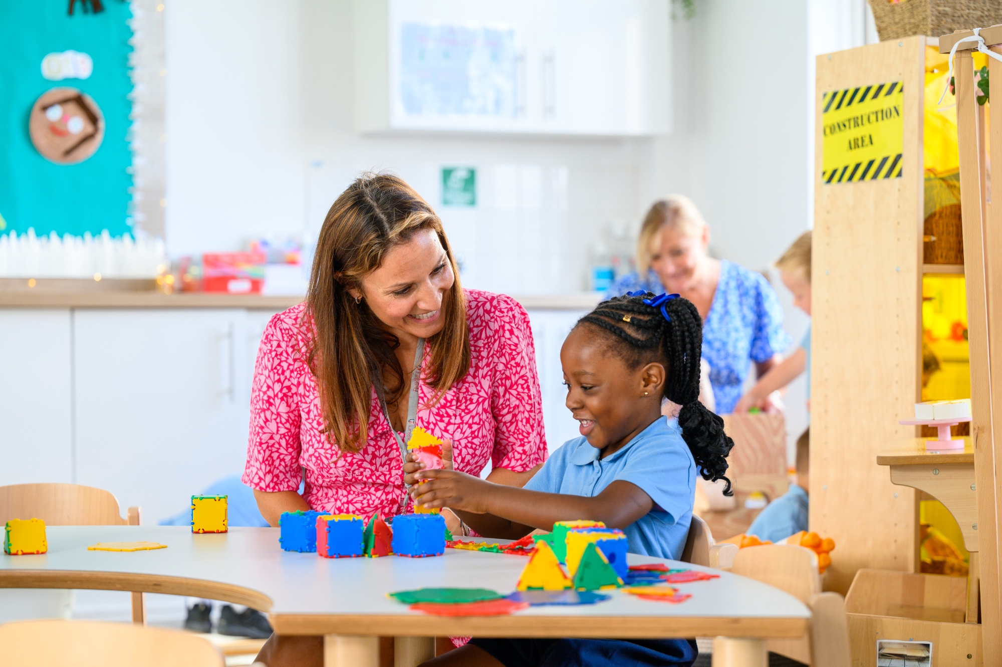 A teacher and primary school pupil in a classroom 