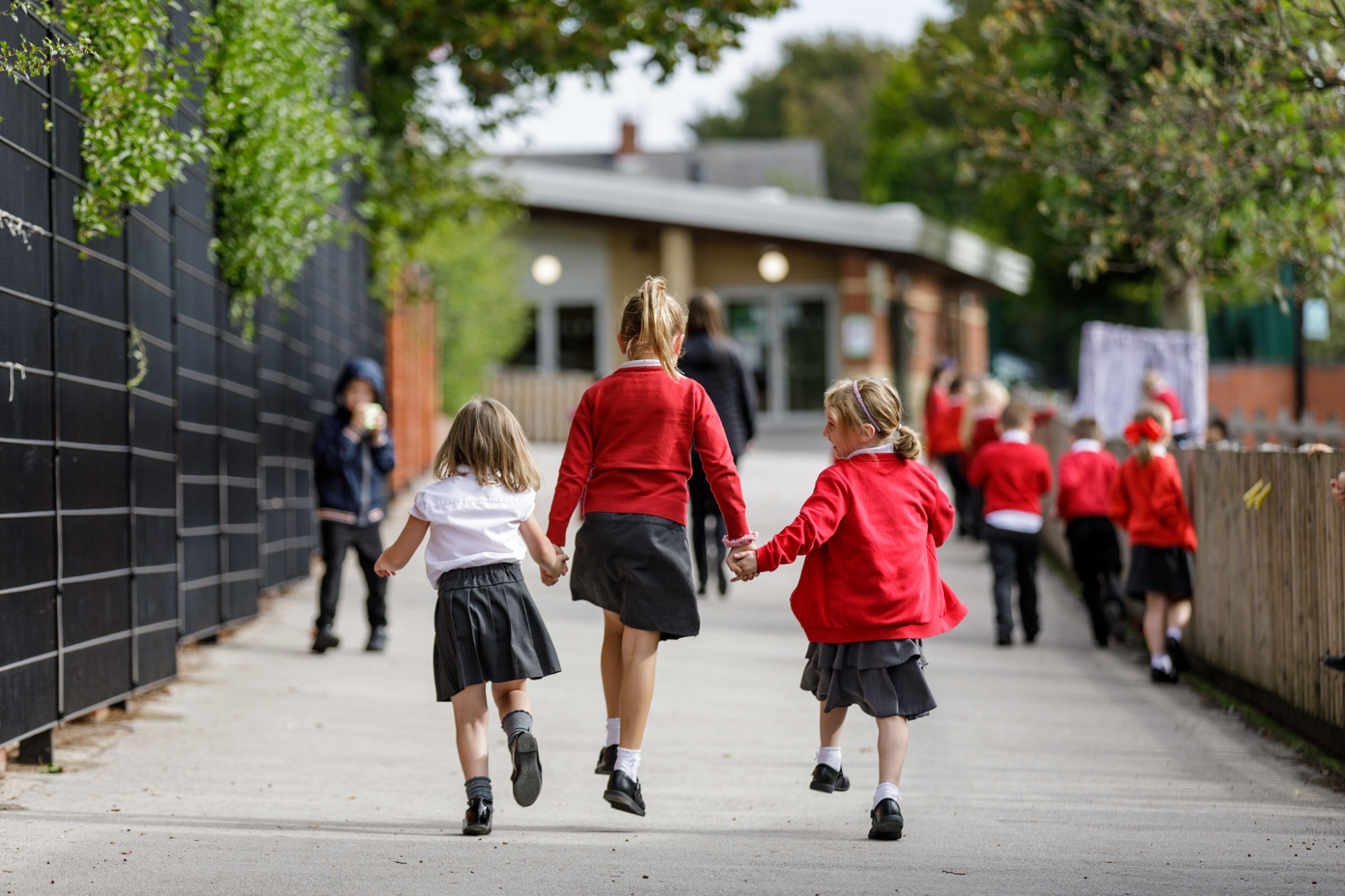 Children skipping into school