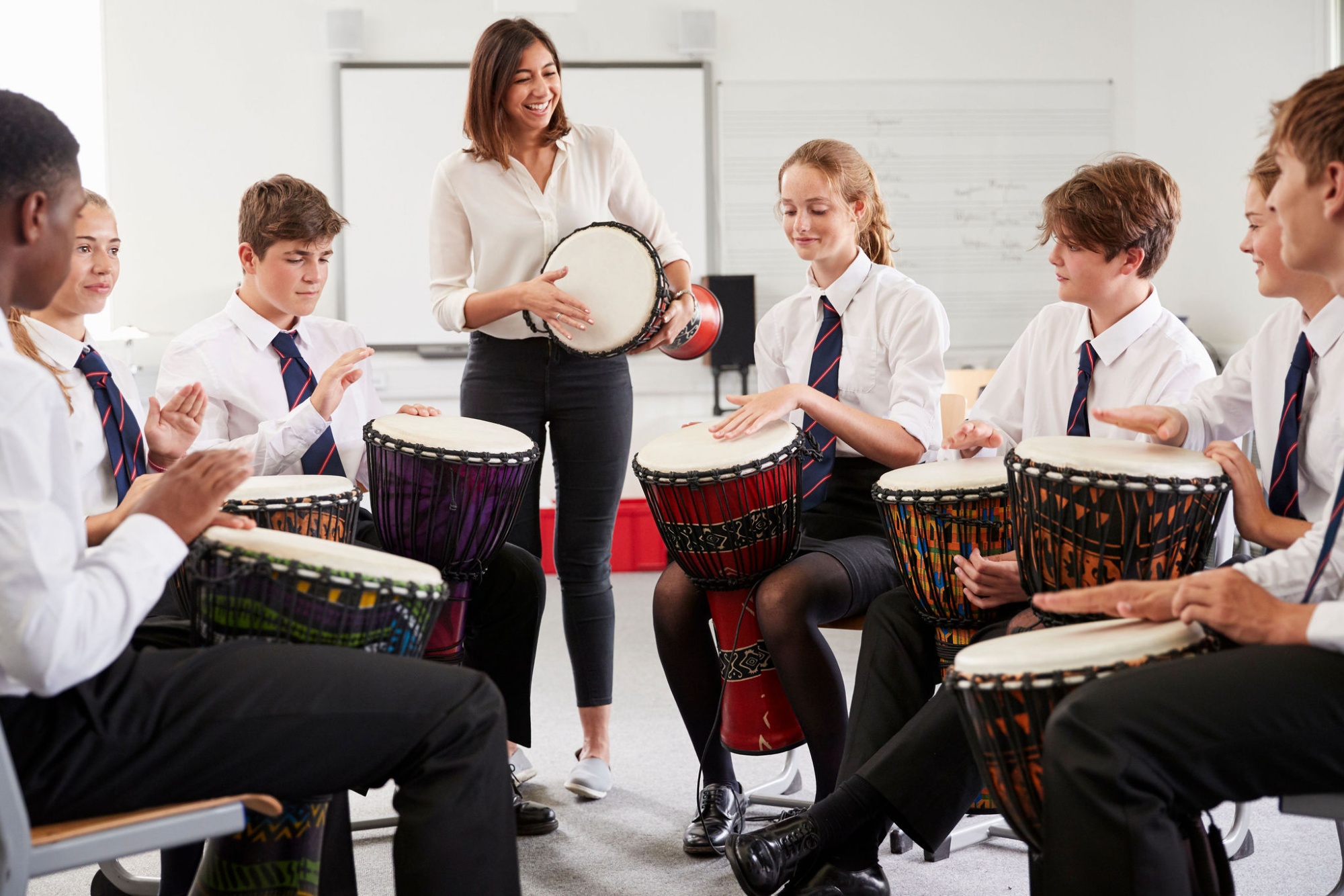 Teacher and Children during a music lesson playing an instrument